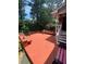 Home featuring a wooden back deck with bench seating, steps, and backyard views at 1165 Vineyard Ct, Stone Mountain, GA 30083