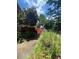 Picture of home's backyard featuring green landscaping and a partial view of the deck at 1165 Vineyard Ct, Stone Mountain, GA 30083