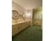 Bathroom featuring a double sink vanity, mirrors, and wallpaper at 1165 Vineyard Ct, Stone Mountain, GA 30083