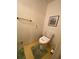 A toilet with a bidet seat sits atop patterned flooring in this practical, yet cozy, bathroom at 1165 Vineyard Ct, Stone Mountain, GA 30083