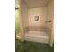 A bathtub with tile surround sits adjacent to a shower with glass doors in this cozy, yet functional, bathroom at 1165 Vineyard Ct, Stone Mountain, GA 30083