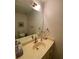 This bathroom boasts an oversized mirror and vanity with a sink, complemented by a clean and functional toilet at 1165 Vineyard Ct, Stone Mountain, GA 30083