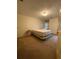 Bedroom with tan carpet, overhead lighting, floral curtains and queen sized bed at 1165 Vineyard Ct, Stone Mountain, GA 30083