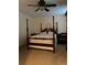 Bedroom with tan carpet and four poster bed at 1165 Vineyard Ct, Stone Mountain, GA 30083