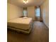 Bedroom with tan carpet, overhead lighting, floral curtains and queen sized bed at 1165 Vineyard Ct, Stone Mountain, GA 30083