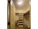 Walk-in closet with wooden hangers and built-in shelving at 1165 Vineyard Ct, Stone Mountain, GA 30083