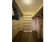 Walk-in closet with built-in shelving and carpet flooring at 1165 Vineyard Ct, Stone Mountain, GA 30083
