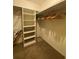 Walk-in closet with wooden hangers and white built-in shelving at 1165 Vineyard Ct, Stone Mountain, GA 30083