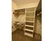 Walk-in closet with wooden hangers and white built-in shelving at 1165 Vineyard Ct, Stone Mountain, GA 30083