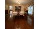 Elegant dining room with hardwood floors, a formal table setting, and a classic chandelier, perfect for gatherings at 1165 Vineyard Ct, Stone Mountain, GA 30083