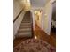 Inviting entryway featuring hardwood floors, a staircase, and a view into another room, creating a warm welcome at 1165 Vineyard Ct, Stone Mountain, GA 30083