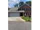 Charming two-story brick home with an attached two-car garage and well-maintained landscaping at 1165 Vineyard Ct, Stone Mountain, GA 30083
