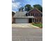 Charming two-story brick home with an attached two-car garage and well-maintained landscaping at 1165 Vineyard Ct, Stone Mountain, GA 30083