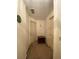 Hallway with three doors and neutral walls at 1165 Vineyard Ct, Stone Mountain, GA 30083