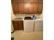 Laundry room featuring a washer, dryer, and upper cabinets, providing a practical and organized space at 1165 Vineyard Ct, Stone Mountain, GA 30083
