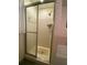 A standing shower with glass doors and tile surround is positioned next to the bathtub in this bathroom at 1165 Vineyard Ct, Stone Mountain, GA 30083