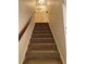 Carpeted stairway leading to the upper level of the home, providing access to bedrooms and other living spaces at 1165 Vineyard Ct, Stone Mountain, GA 30083