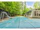 View of the home's covered backyard pool with a slide and an expansive backyard at 1282 Shiloh Trail E, Kennesaw, GA 30144