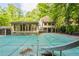 View of the home's covered backyard pool with a diving board and backyard at 1282 Shiloh Trail E, Kennesaw, GA 30144