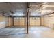 The unfinished basement features a concrete floor, utilities, and access to a garage at 1282 Shiloh Trail E, Kennesaw, GA 30144
