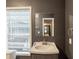 Dark bathroom features a window, vanity, and mirror at 1282 Shiloh Trail E, Kennesaw, GA 30144