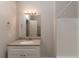 Bathroom with a white single sink vanity and a big mirror at 1282 Shiloh Trail E, Kennesaw, GA 30144