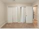 This bedroom has neutral colored walls and carpet with two bi-fold door closets at 1282 Shiloh Trail E, Kennesaw, GA 30144
