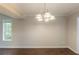 Empty dining room with hardwood floors, modern lighting, and natural light at 1282 Shiloh Trail E, Kennesaw, GA 30144