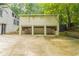 Three-car garage with white siding and a concrete driveway at 1282 Shiloh Trail E, Kennesaw, GA 30144