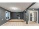 This living room has dark colored walls and carpet with two doors and a window for natural light at 1282 Shiloh Trail E, Kennesaw, GA 30144