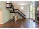 View of living room featuring a staircase, stone fireplace, picturesque windows, and hardwood floors at 1282 Shiloh Trail E, Kennesaw, GA 30144