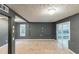 This living room has dark colored walls and carpet with sliding glass doors and a window for natural light at 1282 Shiloh Trail E, Kennesaw, GA 30144