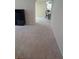 Open-concept living space with neutral carpet flows into the dining area; furniture in the shot at 2234 Oakland Springs Dr, Snellville, GA 30039