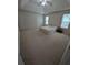 Spacious main bedroom featuring a tray ceiling, carpeted floors, and natural light at 2234 Oakland Springs Dr, Snellville, GA 30039