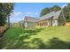 Spacious backyard featuring green lawn and mature trees behind home at 529 Claude Scott Rd, Canton, GA 30115