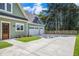 Spacious three-car garage with attached driveway and tasteful landscaping at 529 Claude Scott Rd, Canton, GA 30115