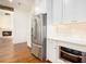 Stylish kitchen featuring stainless steel appliances, white cabinets, and granite countertops at 529 Claude Scott Rd, Canton, GA 30115