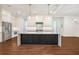 Modern kitchen with an island, stainless steel appliances, and elegant lighting fixtures at 529 Claude Scott Rd, Canton, GA 30115