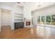 Bright, open living room featuring hardwood floors, a fireplace, and sliding glass doors at 529 Claude Scott Rd, Canton, GA 30115