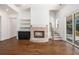 Spacious living room with hardwood floors, a cozy fireplace, and sliding doors to the patio at 529 Claude Scott Rd, Canton, GA 30115