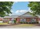 Well-maintained brick home featuring manicured landscaping, inviting front patio, and architectural details at , Buford, GA 30518