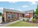 Charming brick home with a well-kept lawn, white picket fence, and cozy front patio at , Buford, GA 30518