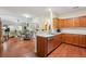 Open kitchen design with wood cabinets, stainless steel dishwasher, and seamless flow to the dining and living area at , Buford, GA 30518