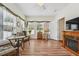 Comfortable sunroom featuring a fireplace, several windows, laminate floors, and wicker furniture at , Buford, GA 30518