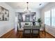 Elegant dining room with a glass-top table, chandelier, and wainscoting detail at 1104 Victory Sw Dr, Atlanta, GA 30310
