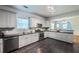 Open kitchen view with stainless appliances, dark granite countertops, and white cabinetry at 1104 Victory Sw Dr, Atlanta, GA 30310