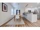 Bright dining area with wood table, modern lighting, and adjacent kitchen at 1445 Monroe Ne Dr # C32, Atlanta, GA 30324