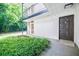 Apartment entrance with front door, green bushes, and exterior walkway at 1445 Monroe Ne Dr # C32, Atlanta, GA 30324