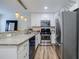Modern kitchen boasts stainless steel appliances, granite countertops and wood-style laminate flooring at 1445 Monroe Ne Dr # C32, Atlanta, GA 30324
