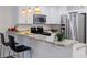 Kitchen featuring granite counters, stainless appliances, and bar seating for casual dining at 1445 Monroe Ne Dr # C32, Atlanta, GA 30324